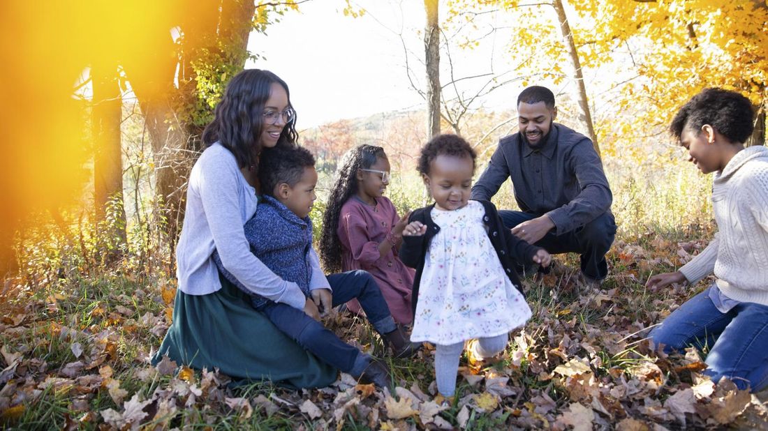  family playing in leaves who needs to compare term vs. whole life insurance