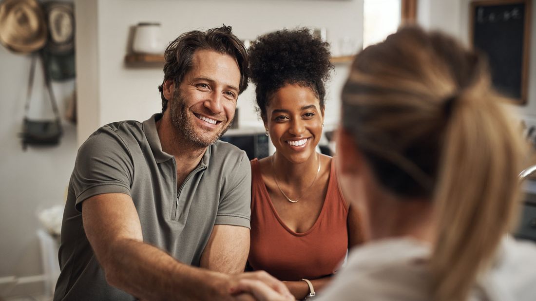 Couple meeting with a life insurance agent in their home