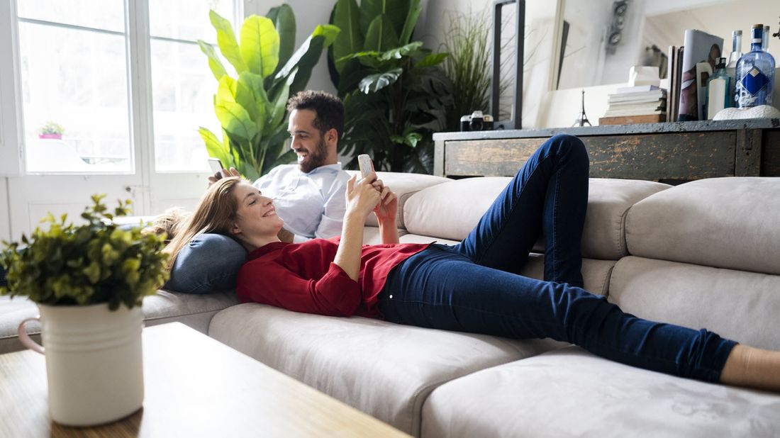 Couple on a couch researching what is financial planning