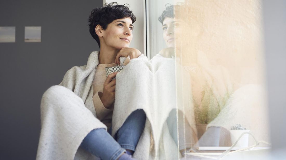 woman in window setting new year intention 