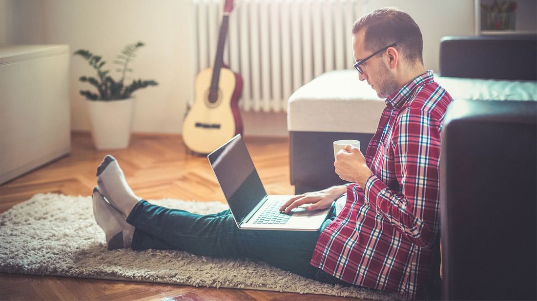 Man in his living room looking up his credit score