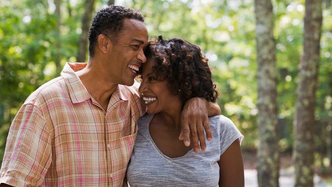 affectionate couple walking in woods