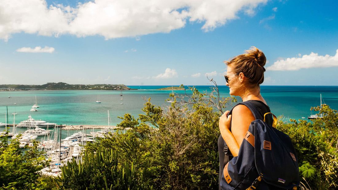 Woman who sailed the Caribbean for 2 years overlooking a harbor