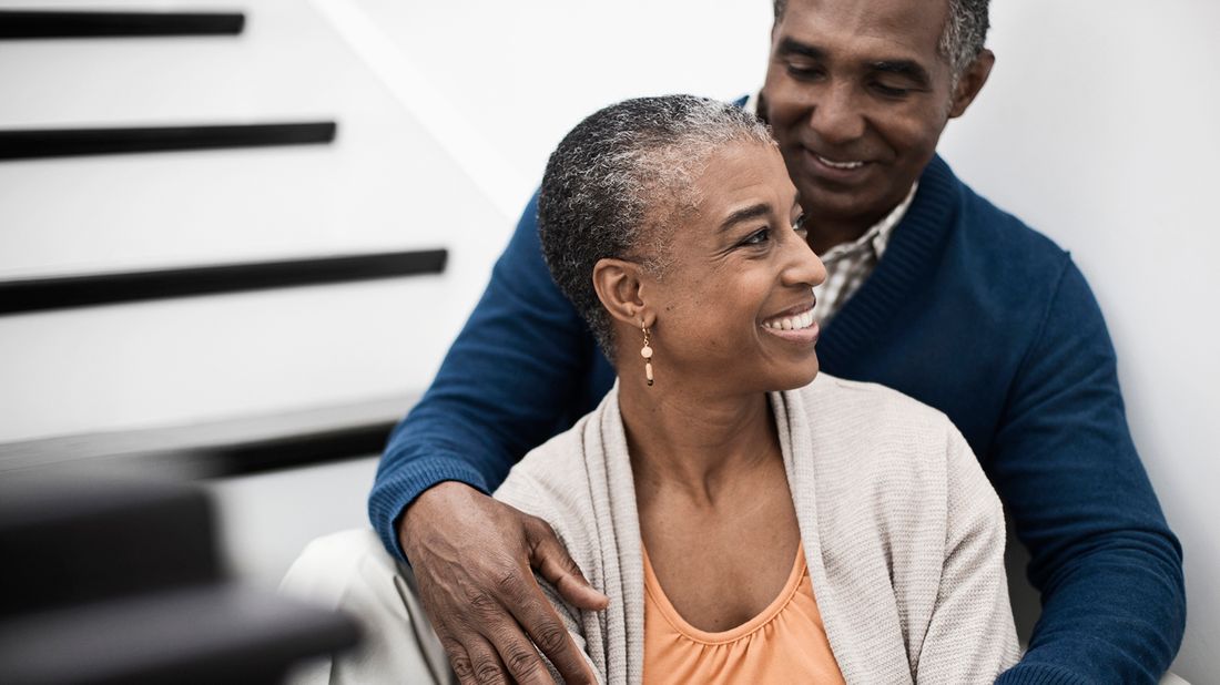 smiling couple sitting on stairs