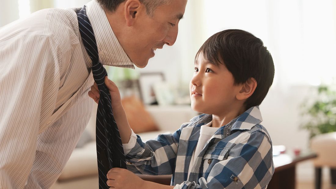 Son adjusting his father's tie.