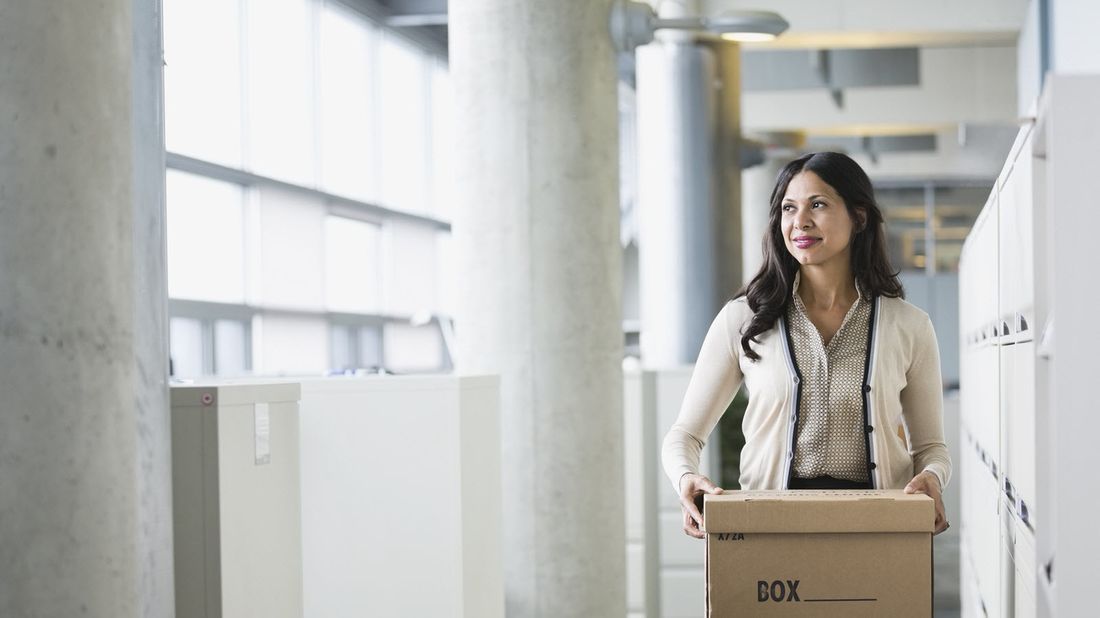 Woman leaving office after losing her job.