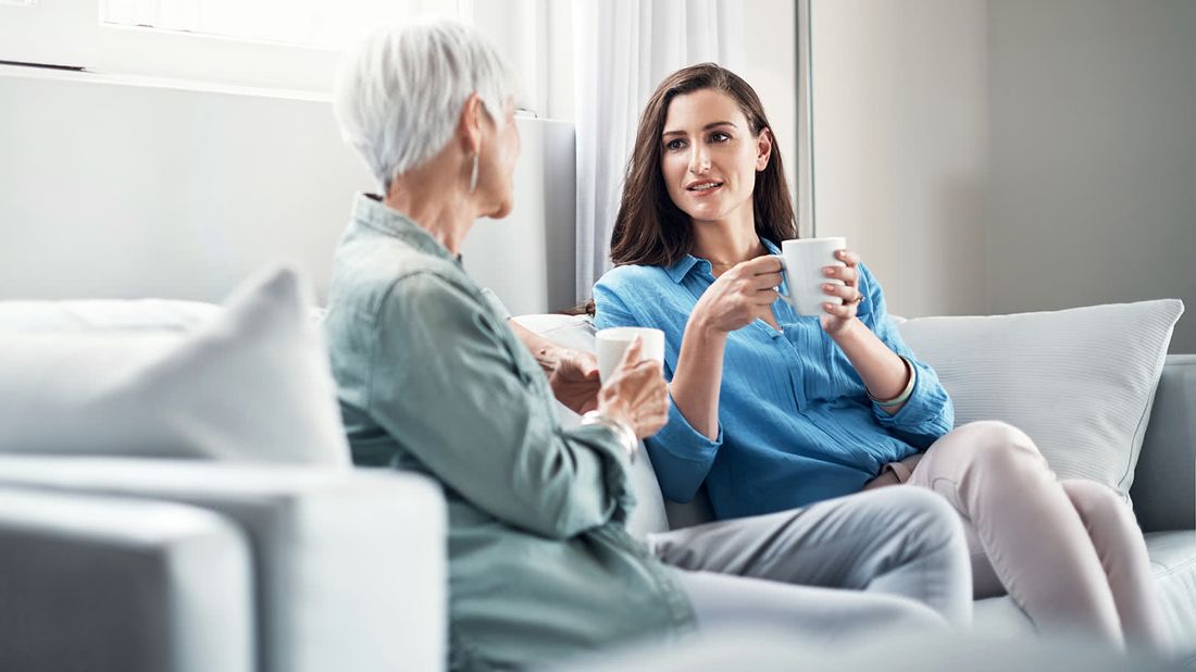 Mother and daughter having coffee.