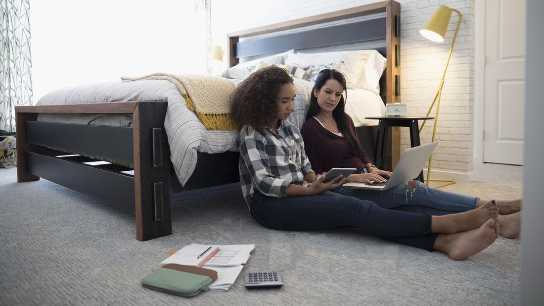 Mother and daughter making sense of a college acceptance letter.