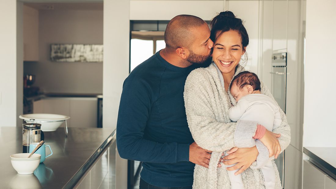 new parents and baby in kitchen