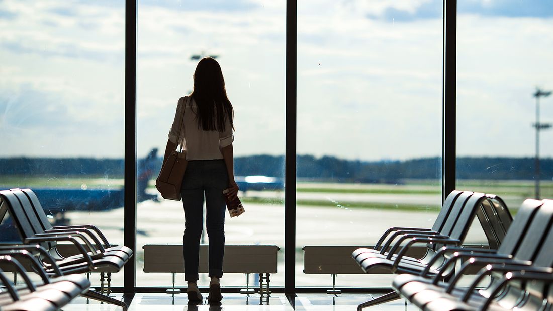 Woman waiting for a flight at the airport.