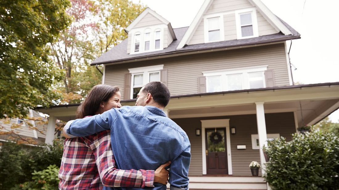 Couple looking at a house.