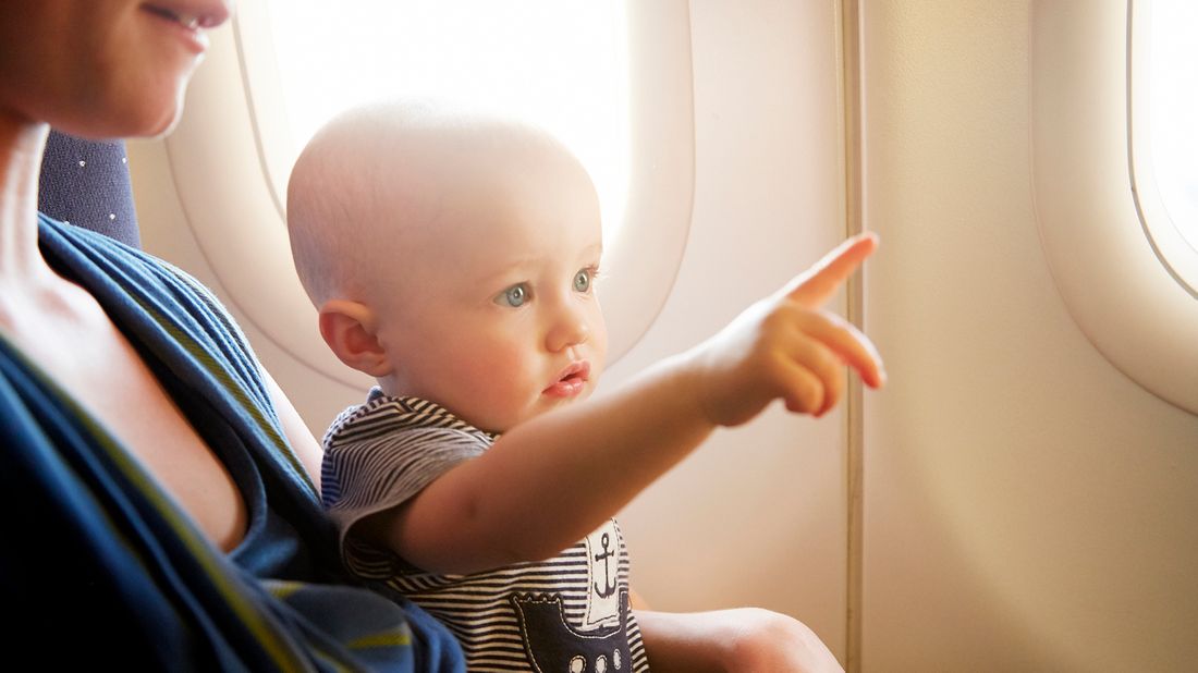 baby on plane pointing