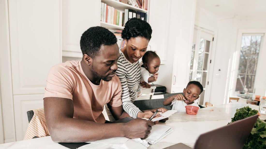 A mother and father review finances with their kids