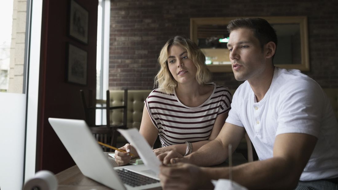 A young couple reviews their finances together