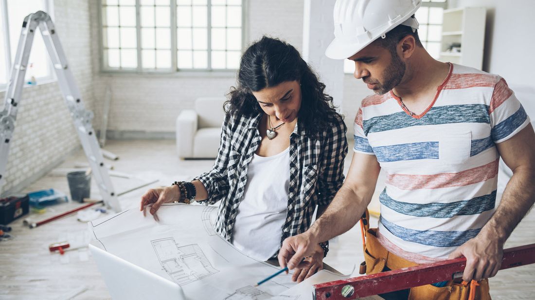 Woman and contractor discussing plans.