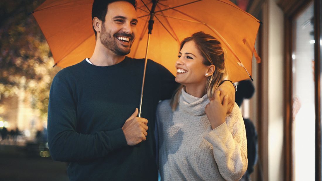 Couple walking on a rainy night discussing how do variable annuities work.