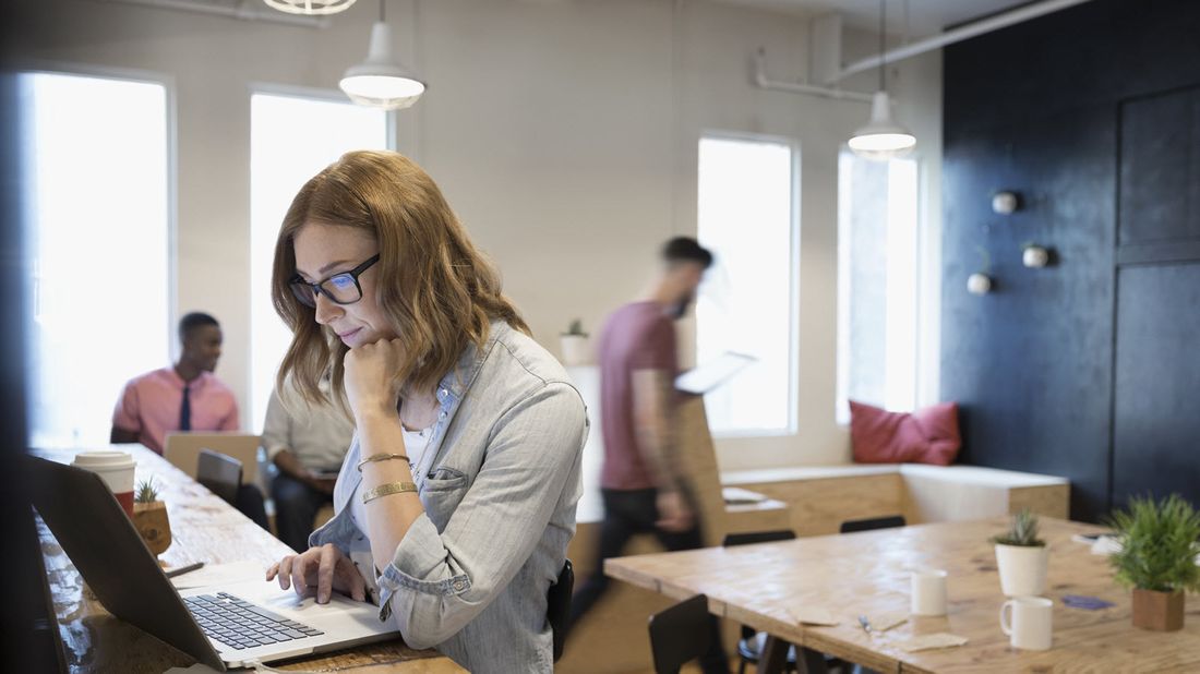 A woman checks her investments on a computer