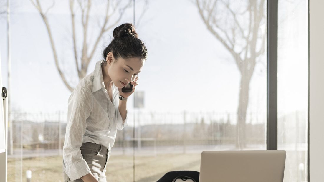 woman on the phone at her desk