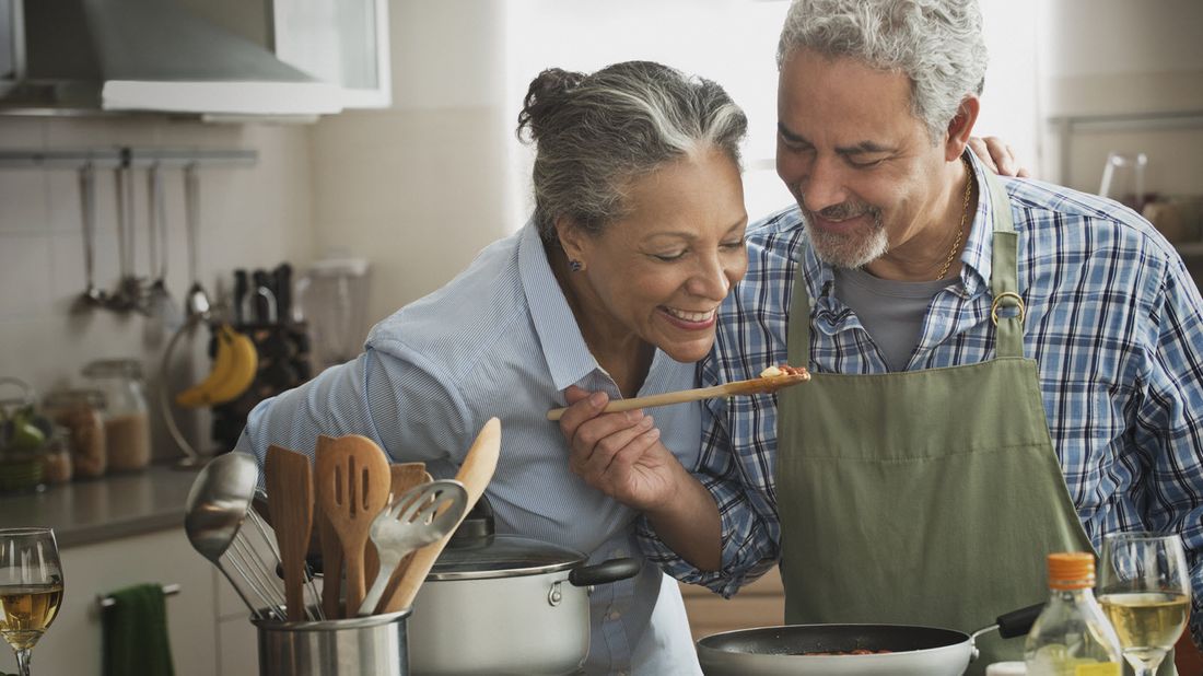 A Hispanic couple cooking a meal