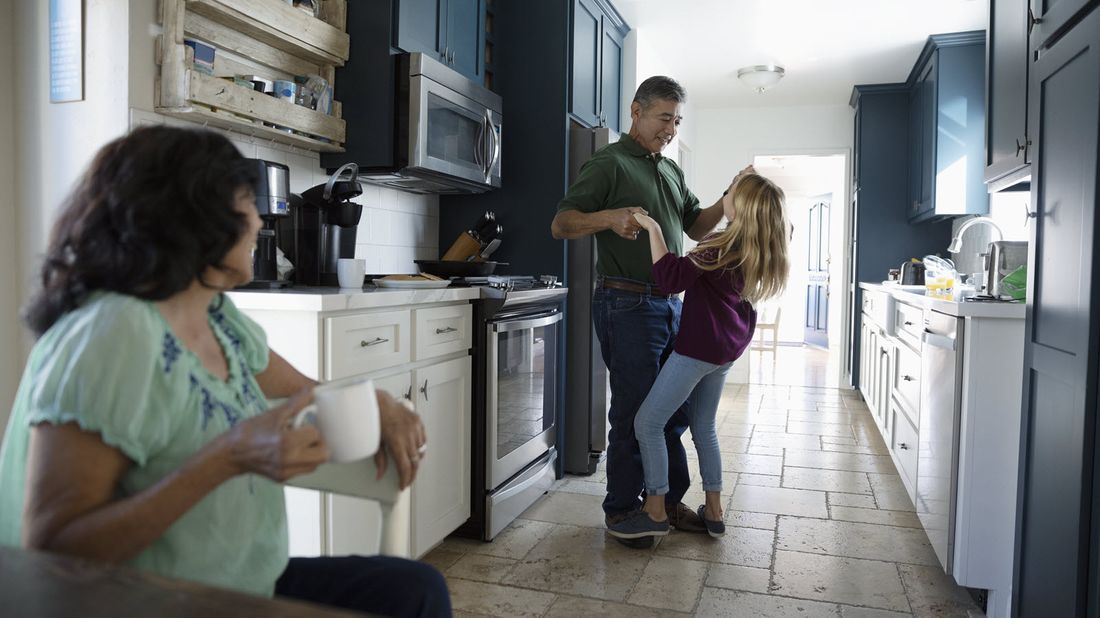 Grandfather dancing with granddaughter who will benefit from his irrevocable life insurance trust.