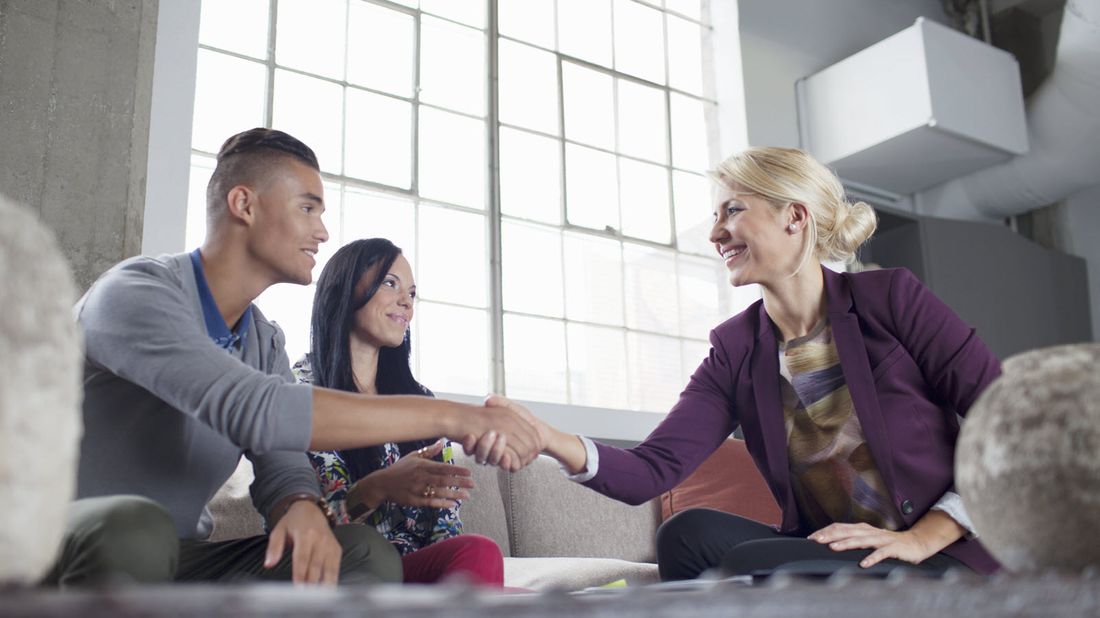 A couple is asking a financial advisor how she is paid.