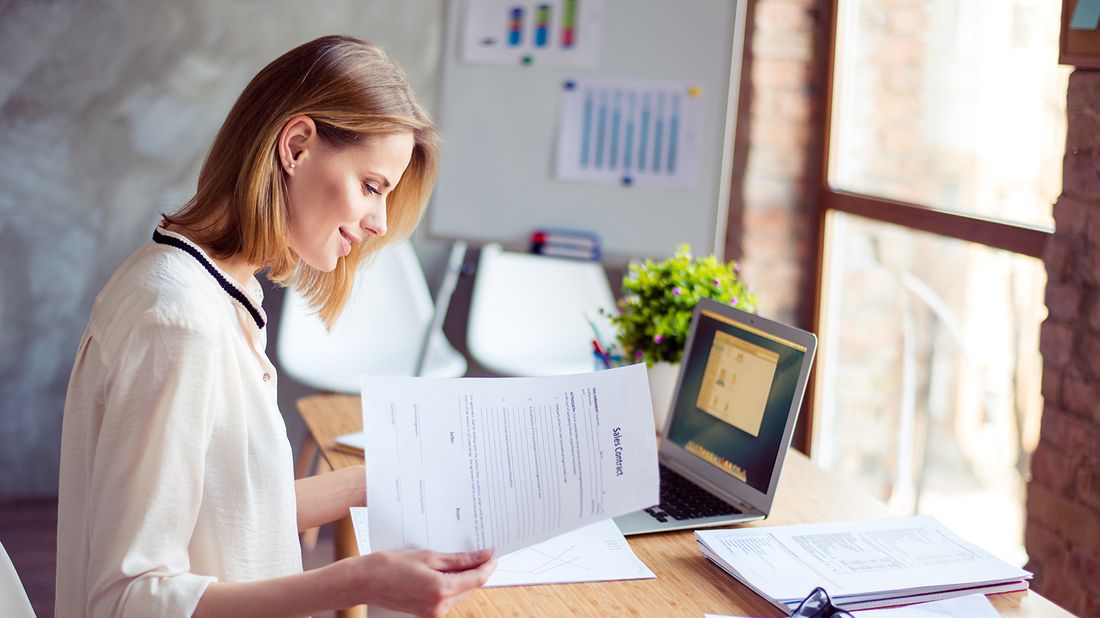 woman applying KonMari method on financial paperwork