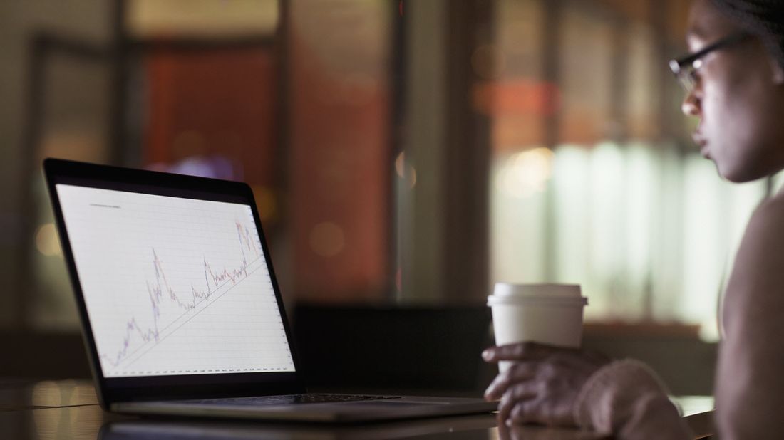 A woman studies the chart of an unidentified stock or fund