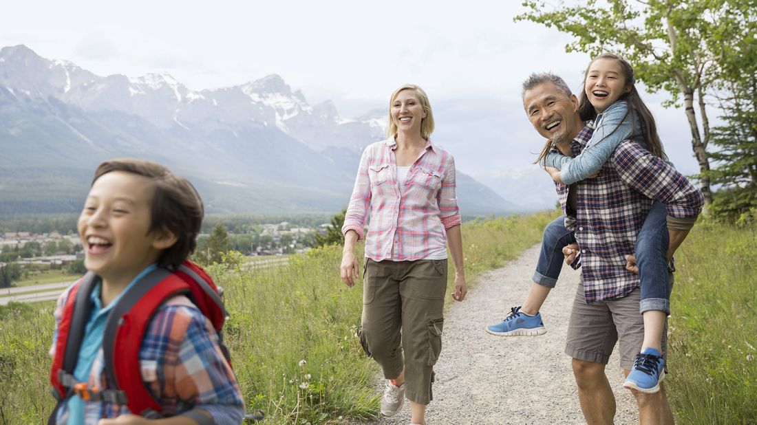 Family hiking at a ski resort in the summer.