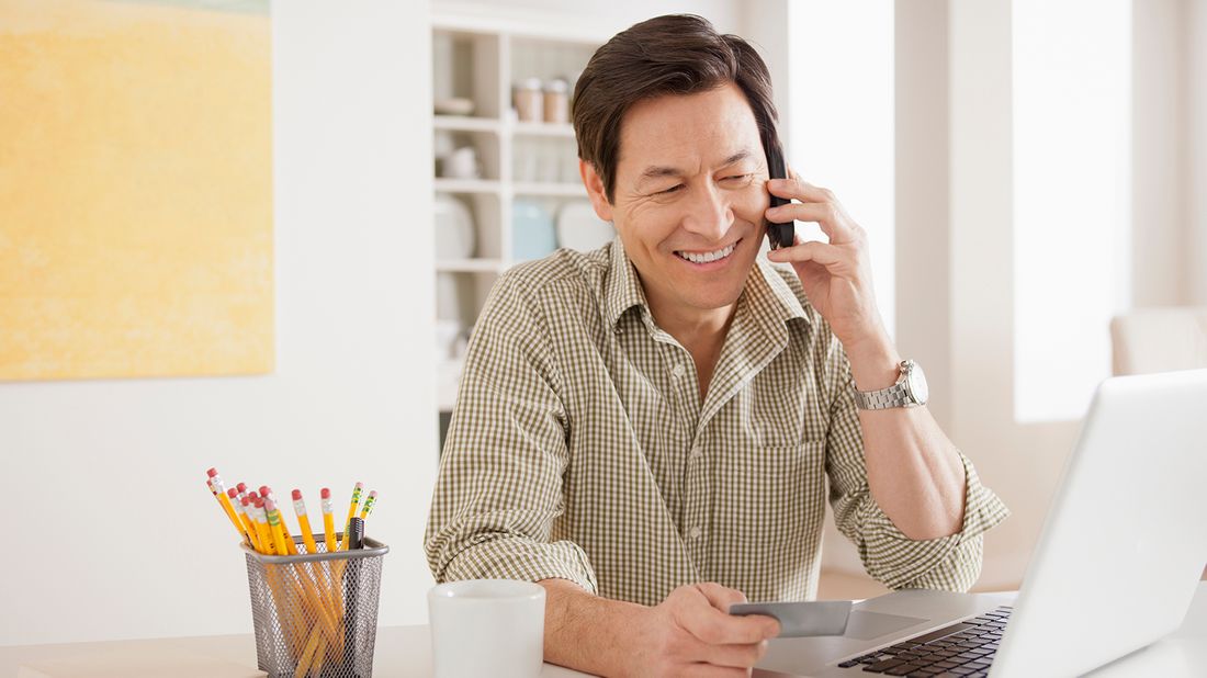 man negotiating credit card interest rate over the phone