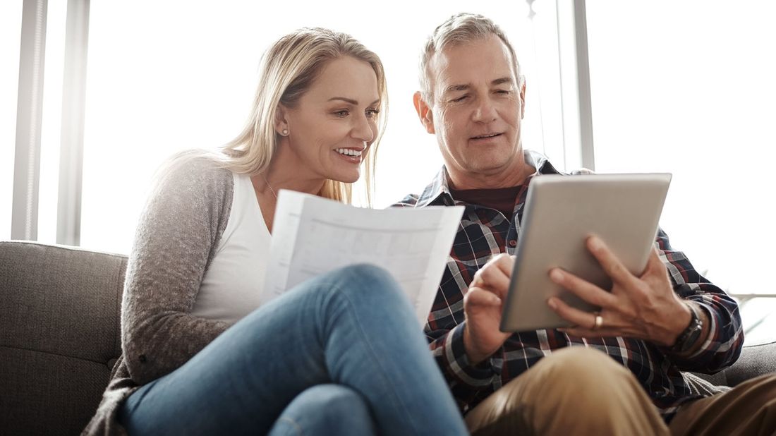 Couple looking at a tablet researching whether an annuity is an investment or an insurance policy.