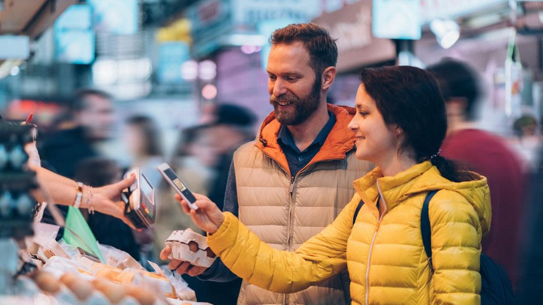 Young couple shopping and paying with their digital wallet