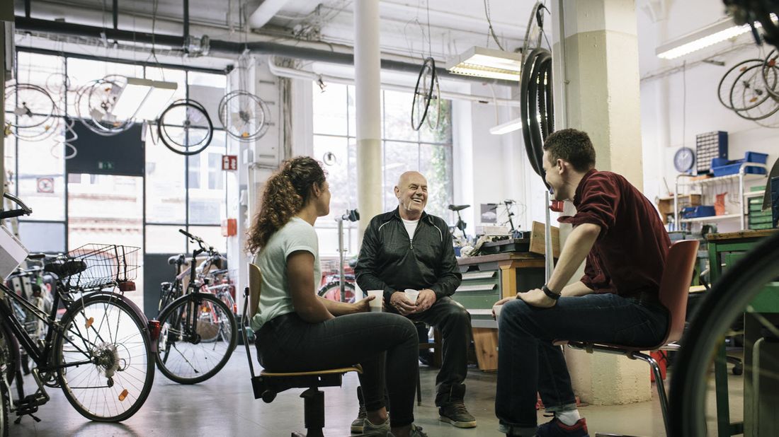 A bike shop owner discusses SECURE Act with employees