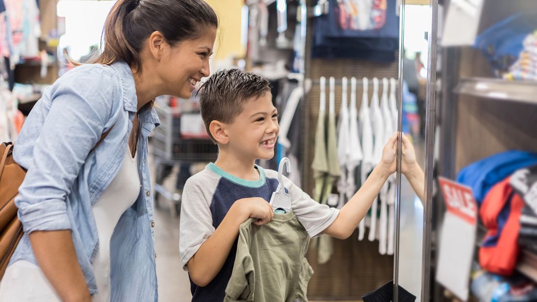 Mother and son shopping for back-to-school clothes.