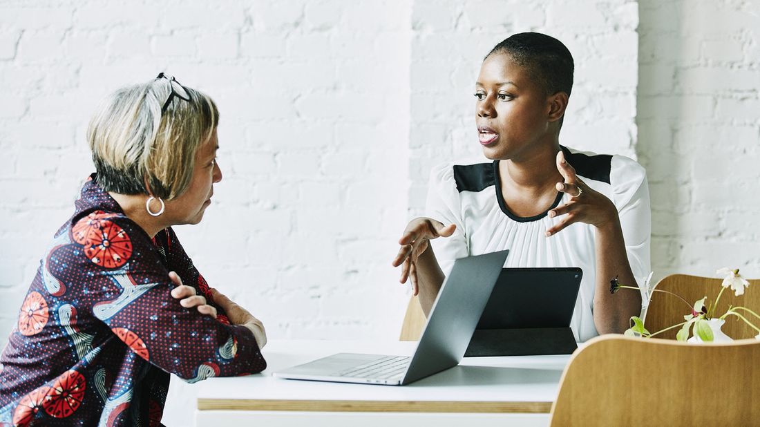 A woman speaking with her wealth manager