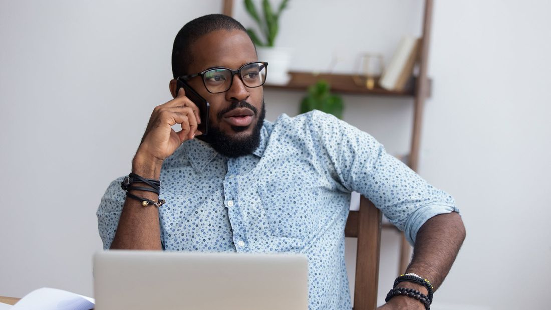 A millennial using a laptop and talking to advisor about retirement