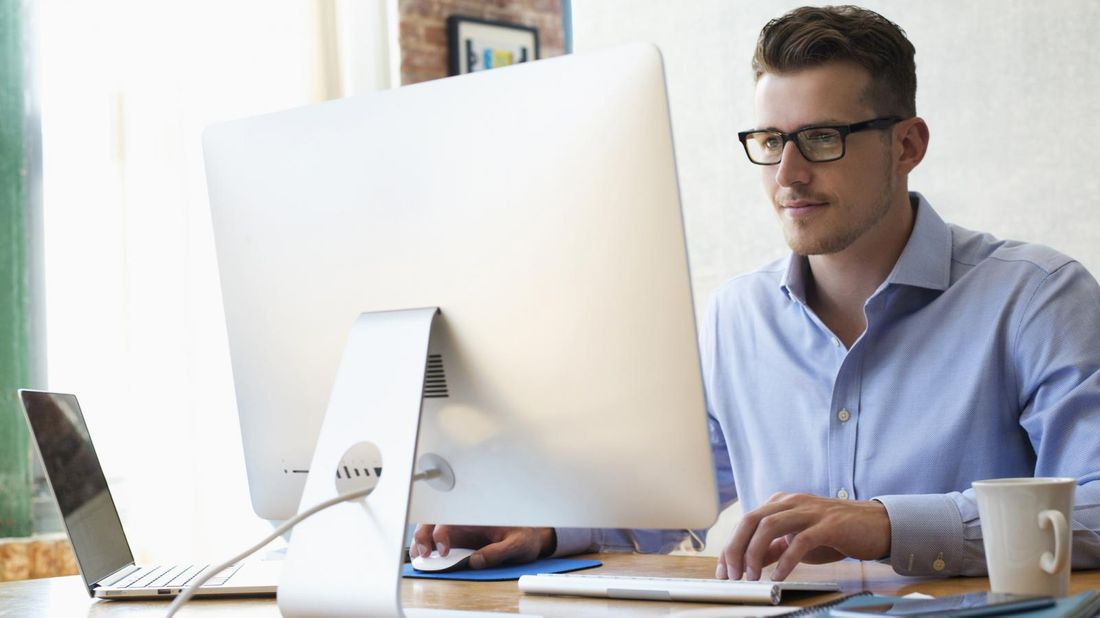 businessman sending emails from office