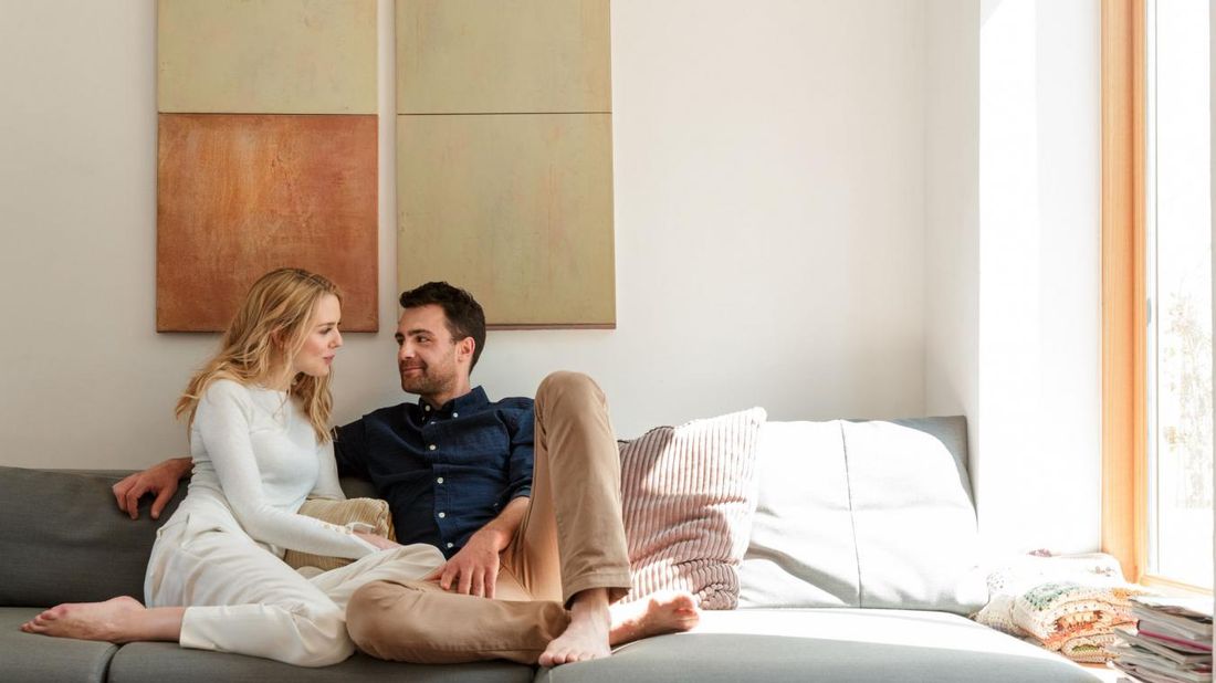 Couple sitting on sofa together