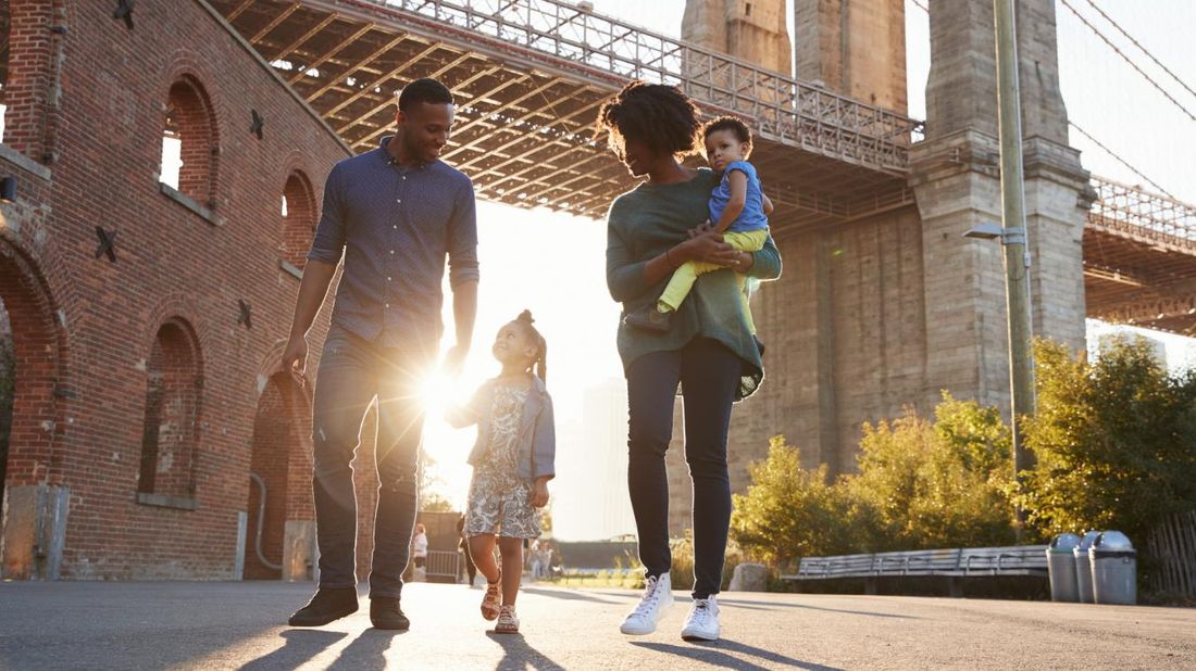 Family walking under a bridge