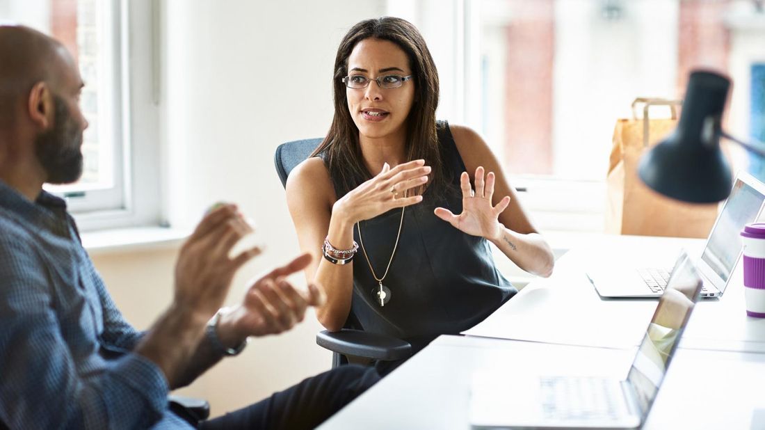  Man and woman at table discussing manager holding you back