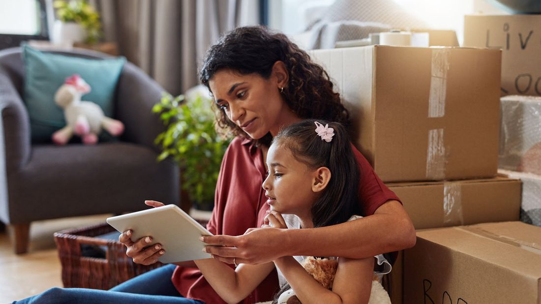 Woman reading from a tablet with her daughter