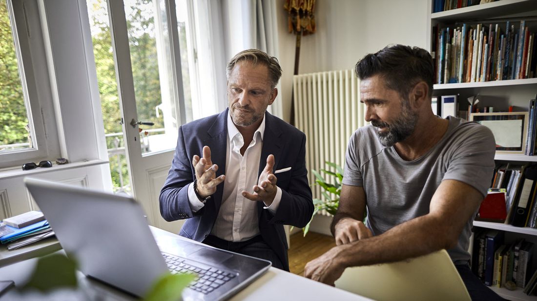 A financial advisor discusses a plan with his client