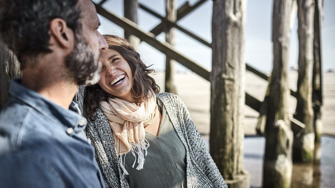 Husband and wife under a pier discussing if they should update their will.