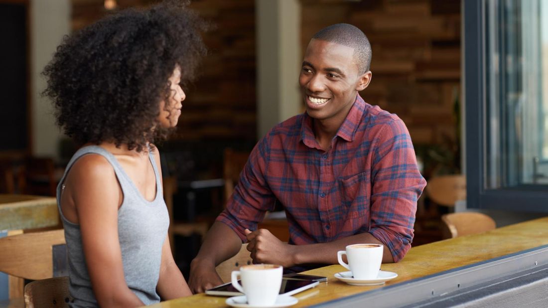 A couple discussing money over coffee