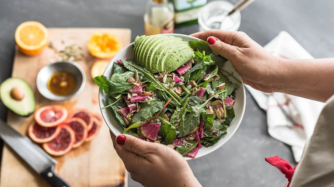 woman holding bowl of salad