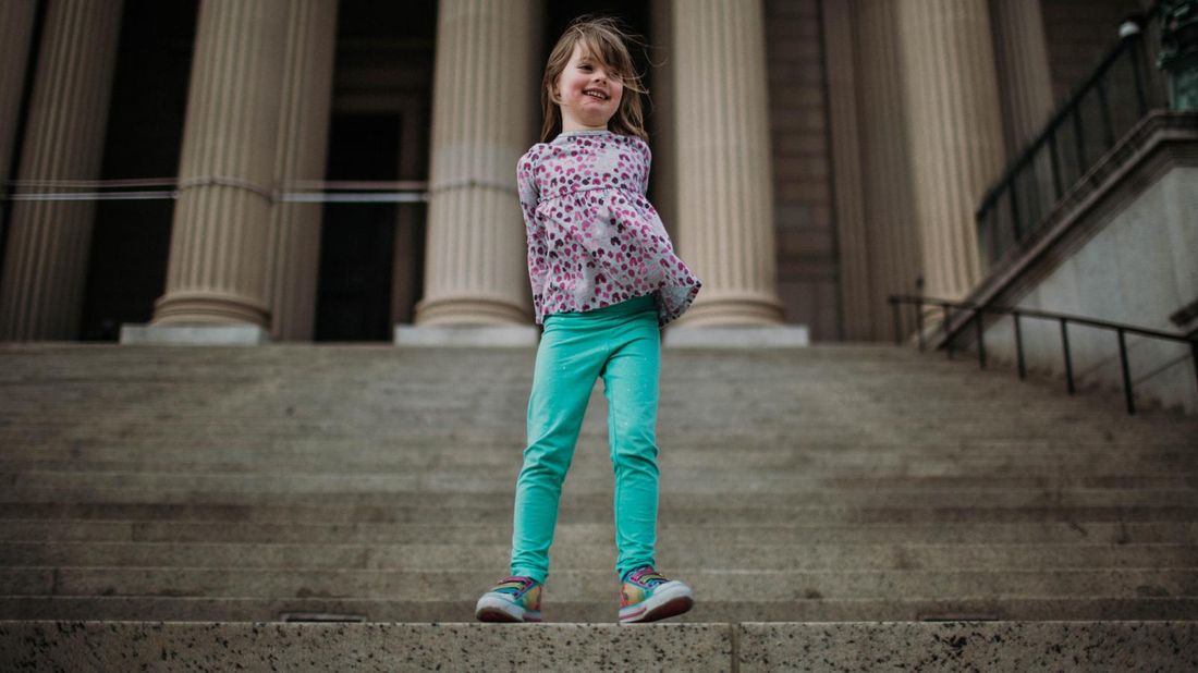 Girl on steps in Washington, DC on a financial vacation 