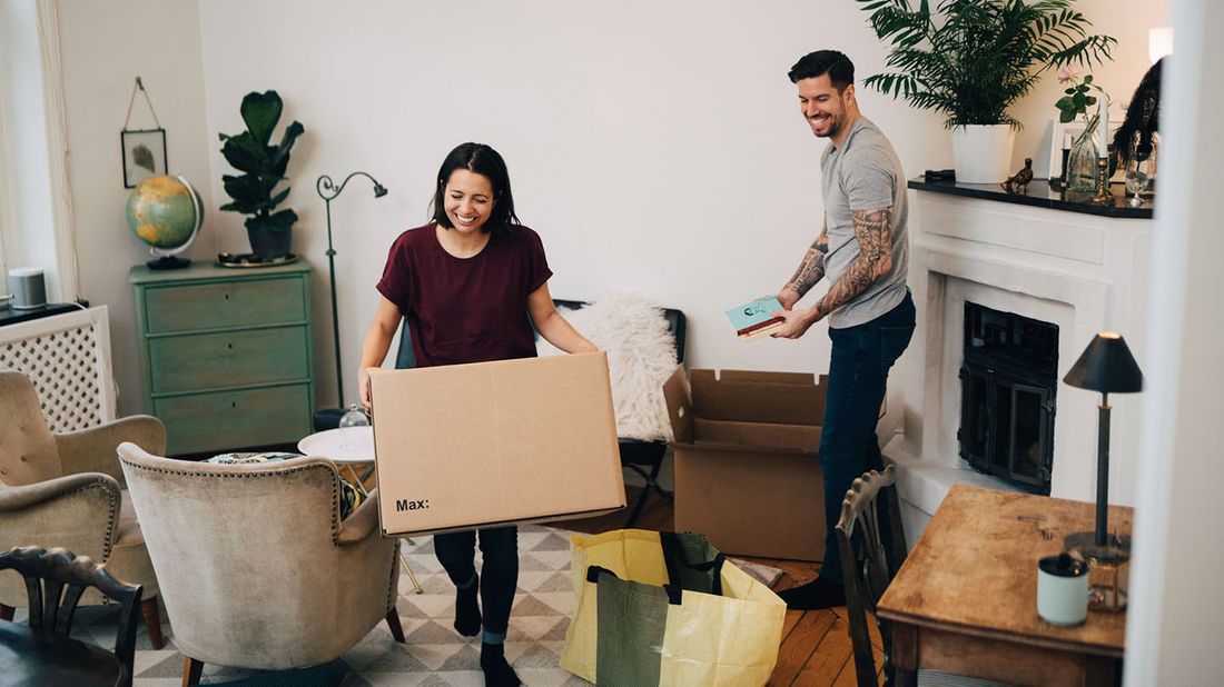 couple unpacking boxes in apartment