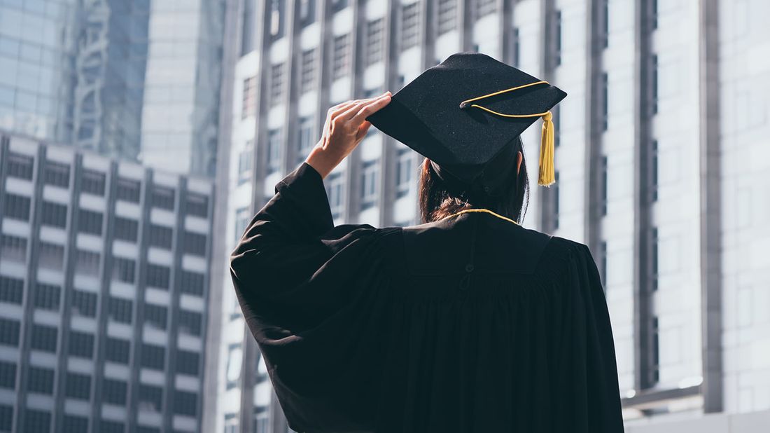 graduate looking out at skyscrapers