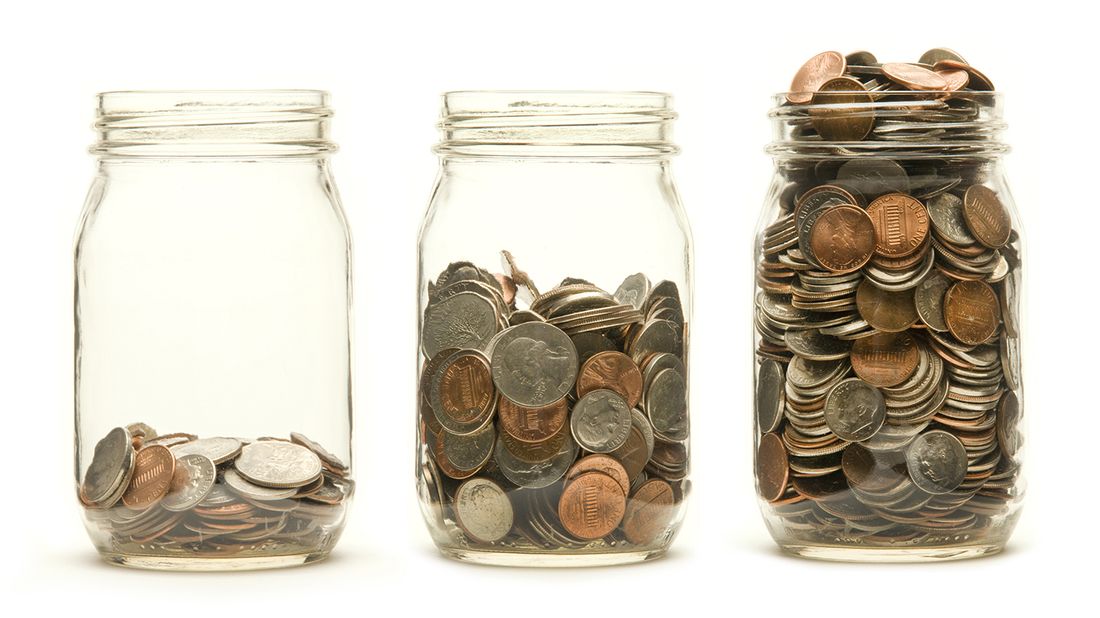 Three glass jars holding different levels of coins