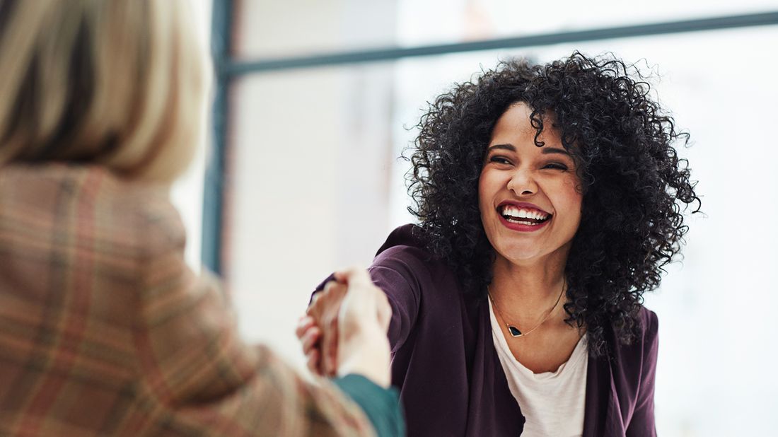 Woman getting a raise, shaking hands