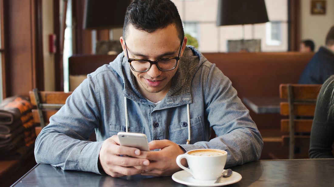 man in coffee shop on his phone